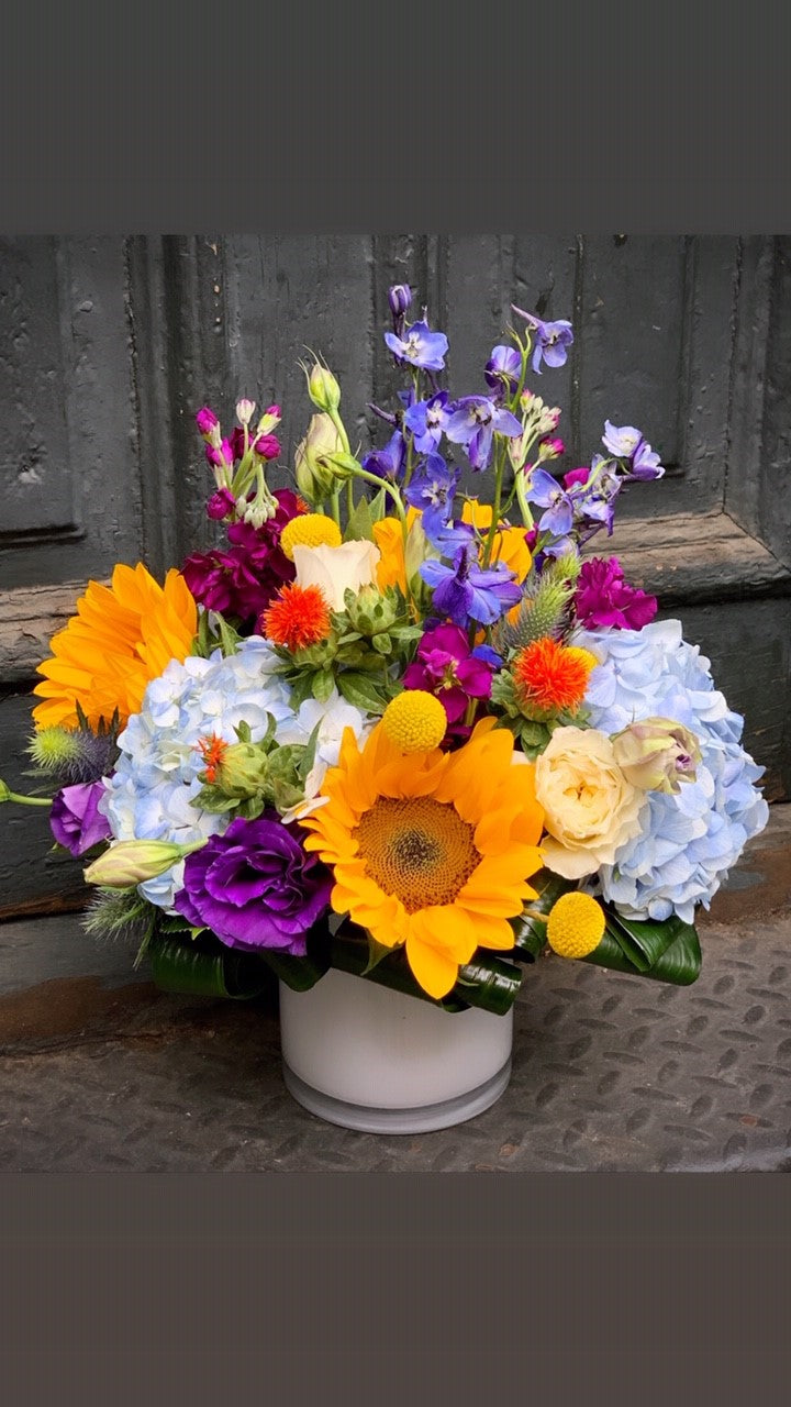 sunflowers, hydrangea, delphinium, stock, lisianthus, and mixed wildflowers