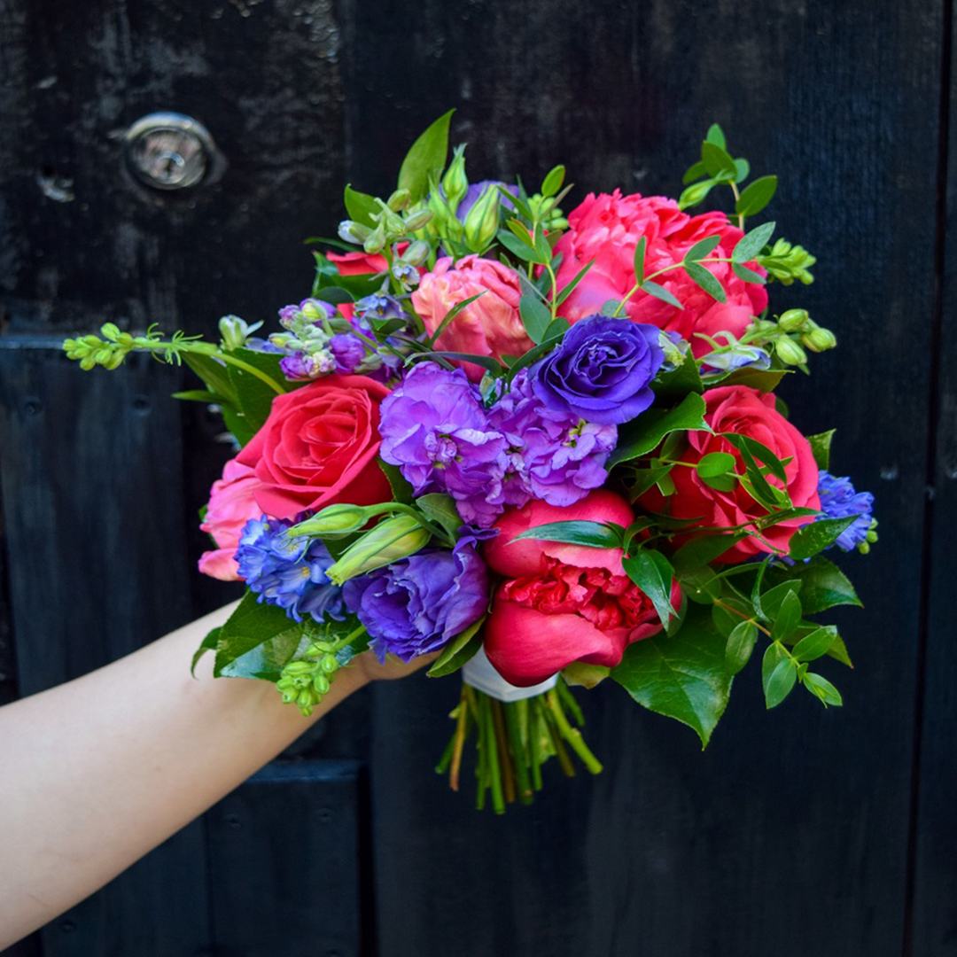 brightly colored blooms paired with garden style greenery