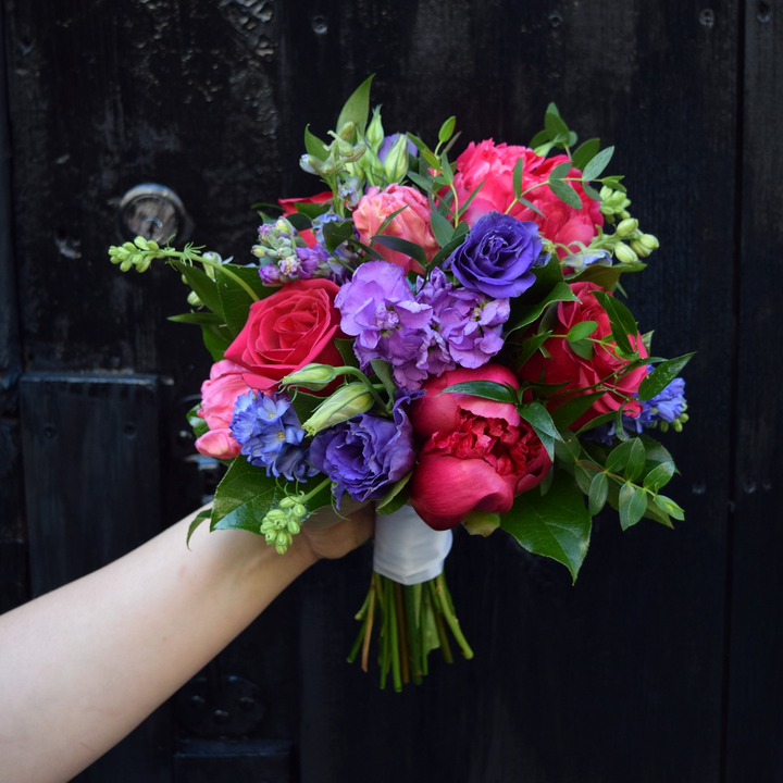 brightly colored blooms paired with garden style greenery