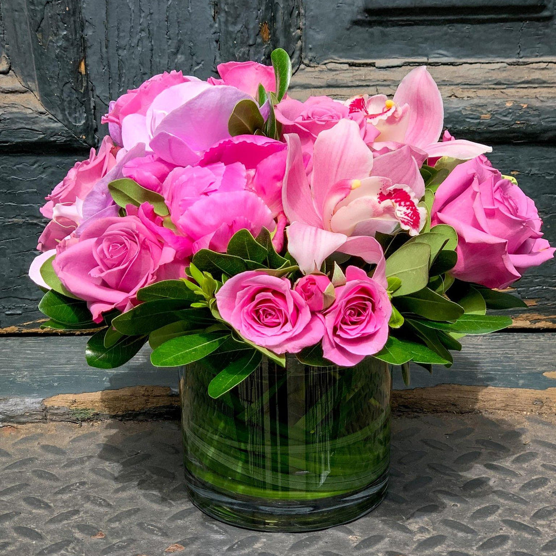 pink flowers including peony, orchids, and roses